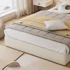 A bedroom scene with a bed, blankets, pillows, and a rug. Produktbild-Vorschau
