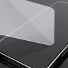 A close-up shot of a clear screen protector being applied to a dark smartphone. Voir les images du produit