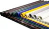 Several rolls of colored PVC tarpaulin are laid out diagonally on a white background. Voir les images du produit
