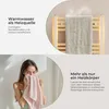 A split image showing a towel warmer with a towel on it and a woman drying her face with a towel. Produktbild-Vorschau