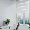 An office or home office setting with a desk, chair, window with blinds, and some office supplies. Voir les images du produit