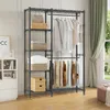 A metal garment rack with shelves, displaying clothes and storage items, set against a light-colored wall and next to a window with green curtains. Voir les images du produit