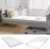 A child's bed with pillows and a mattress, with additional images of the mattress in its packaging. Voir les images du produit