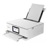A white Canon PIXMA TS8751 printer is shown from a slightly elevated front-left angle against a white background. The printer has a paper loaded in the top feeder and the output tray extended. Produktbild-Vorschau