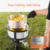 A person is using a propane fryer outdoors to cook french fries. Anteprima dell’immagine prodotto