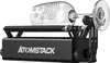 A black ATOMSTACK R3 PRO rotary roller attachment is shown with a clear glass wine glass engraved with stars and a logo, resting on the roller. Náhled obrázku produktu