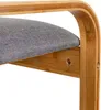 Close-up of a wooden stool with a gray fabric seat. Produktbild-Vorschau