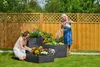 Two women are gardening in a backyard, tending to raised garden beds. Voir les images du produit