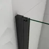 A close-up view of a black shower door hinge and a green glass panel against a tiled wall. Produktbild-Vorschau