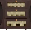 A close-up view of a wooden sideboard with three drawers, each featuring a rattan insert and a wooden knob. Produktbild-Vorschau