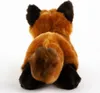 A plush toy fox seen from the back, lying down. Produktbild-Vorschau