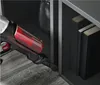 A vacuum cleaner is shown being used to clean the floor next to a bookshelf with books. Produktbild-Vorschau