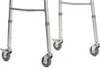 Close-up of the wheels and lower legs of a walker. Podgląd zdjęcia produktu