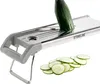 A close-up shot of a mandoline slicer with a cucumber being sliced and a pile of cucumber slices. Produktbild-Vorschau