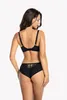 A woman is shown from the back wearing a black bra and black underwear. Produktbild-Vorschau
