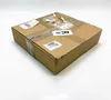 A closed cardboard box with shipping labels and tape. Produktbild-Vorschau