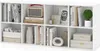 A white cube storage unit filled with books, decorative items, and storage baskets. Produktbild-Vorschau