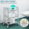 A multi-shelf stainless steel cart with medical supplies and towels, with a medical device on the top shelf. The cart is in a clinical or laboratory setting. Produktbild-Vorschau