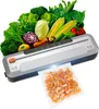 A vacuum sealer machine is shown with a variety of fresh vegetables and a bag of shrimp being sealed. Podgląd zdjęcia produktu