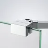 A close-up view of a chrome shower wall stabilizer bar attached to a glass panel. Podgląd zdjęcia produktu
