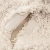 A close-up view of a cream-colored, fluffy material with two white velcro strips visible. Anteprima dell’immagine prodotto