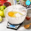 A digital kitchen scale with a bowl of flour and eggs for baking. Produktbild-Vorschau