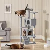A multi-level cat tree with two cats, one on top and one in a lower cubby, in a living room setting. Produktbild-Vorschau