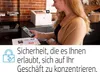 A woman is using a smartphone to interact with a printer in an office setting. Podgląd zdjęcia produktu