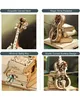 A collage of four images showcasing different features of a wooden mechanical cello model. Náhľad obrázku produktu
