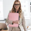 A woman in a business suit holds a pink laptop sleeve in an office setting. Produktbild-Vorschau