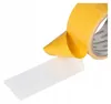A roll of double-sided tape with one side peeling away. Produktbild-Vorschau