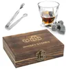 A whiskey stones gift set including a wooden box, tongs, a glass of whiskey, and whiskey stones. Produktbild-Vorschau