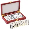 A set of dominoes in a red wooden box, with some dominoes laid out in front of the box. Náhľad obrázku produktu