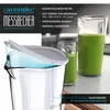 A close-up of a measuring cup with a lid, next to two glasses filled with a green smoothie. Náhľad obrázku produktu