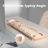 A keyboard and mouse set is shown on a desk, with a close-up inset of a keyboard stand. Produktbild-Vorschau