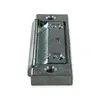 A close-up, side view of a metal hinge component on a white background. Produktbild-Vorschau