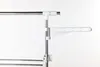 A close-up view of a section of a drying rack, showing its metal poles and white plastic connectors and accessories. Produktbild-Vorschau