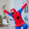 A man in a Spiderman costume is posing in a room with a desk and chair. Anteprima dell’immagine prodotto