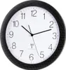A close-up view of a wall clock with a carbon fiber-like frame. Voir les images du produit