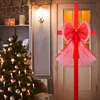 A decorated door and Christmas tree in a festive setting. Náhled obrázku produktu