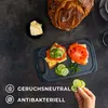 A cutting board with sandwiches and bread on a dark surface. Anteprima dell’immagine prodotto