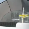 An outdoor whirlpool covered by a sunshade, with a drink in the foreground. Náhled obrázku produktu