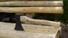 An axe rests on a wooden bench made of logs. Anteprima dell’immagine prodotto