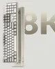 A close-up, angled view of a white mechanical keyboard with a large graphic of '8K' in the background. Produktbild-Vorschau