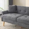 A close-up view of a gray sofa with tufted cushions and wooden legs. Produktbild-Vorschau