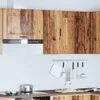 A kitchen scene with cabinets, a range hood, and kitchen utensils. Produktbild-Vorschau