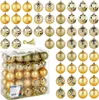 A collection of gold Christmas tree ornaments in various styles and a clear plastic box containing more ornaments. Náhled obrázku produktu