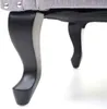 Close-up view of the legs of a gray upholstered chair. Náhled obrázku produktu