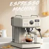 A beige espresso machine is shown in a kitchen setting, with coffee brewing into a glass cup. Náhled obrázku produktu