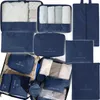 A collection of blue fabric packing cubes and bags, some filled with clothing, arranged in a collage. Anteprima dell’immagine prodotto